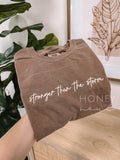 Emb. Stronger Than the Storm Tee